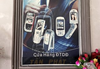 Old Vietnamese poster featuring flip phones